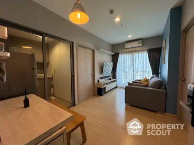 Spacious modern studio apartment with integrated living and sleeping area, featuring wooden flooring, contemporary furniture, and ample natural light.