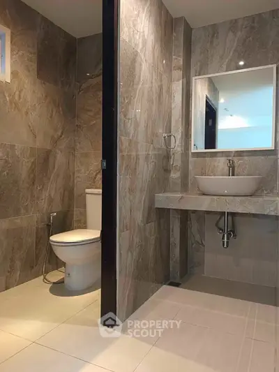 Modern bathroom with elegant stone tiles and sleek fixtures