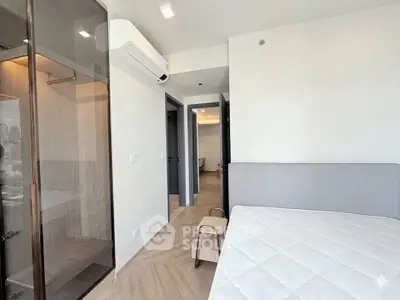 Modern bedroom with sleek design and ample natural light, featuring a stylish wardrobe and air conditioning.