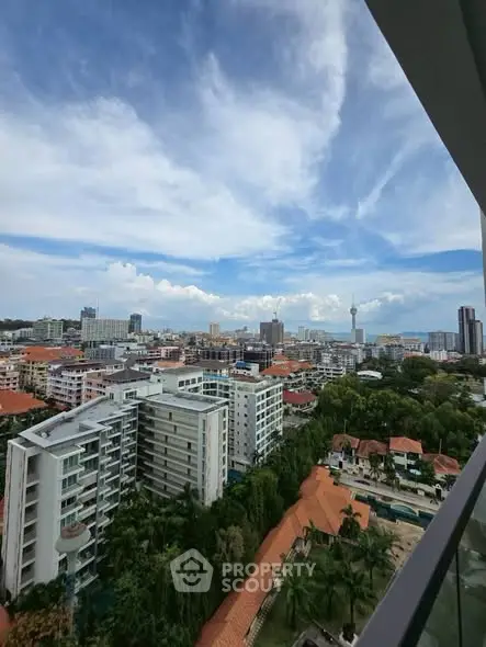 Stunning cityscape view from high-rise balcony with clear blue sky