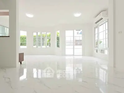 Spacious and bright living room with marble flooring and large windows