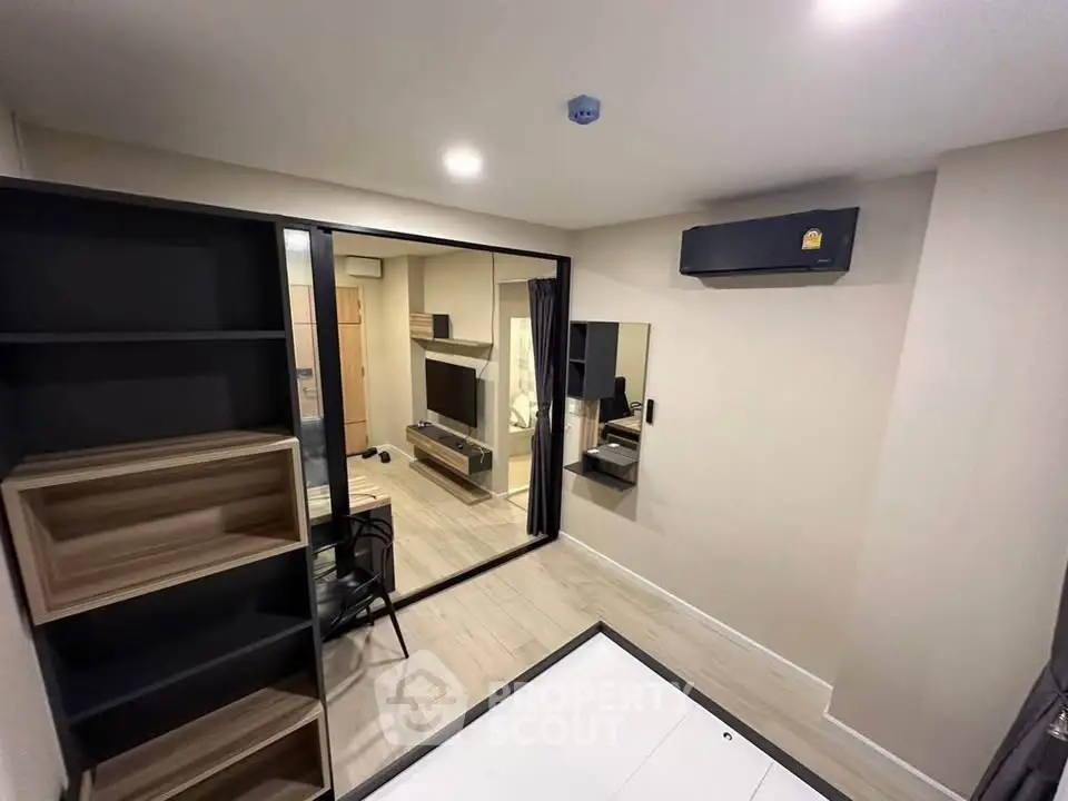 Modern study room with sleek furniture and air conditioning in a contemporary apartment.