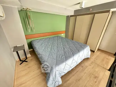 Modern bedroom with stylish decor and ample storage space