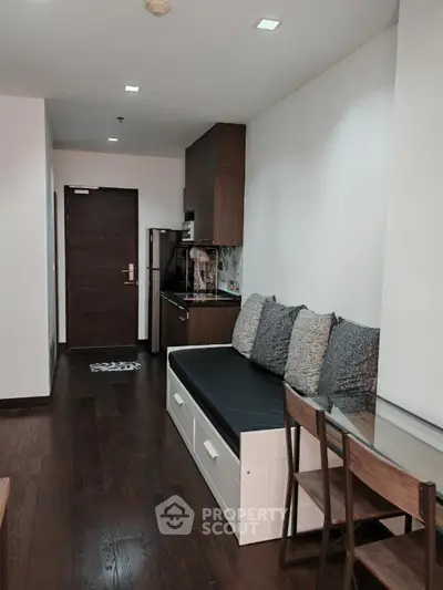 Modern apartment interior with sleek kitchen and cozy seating area