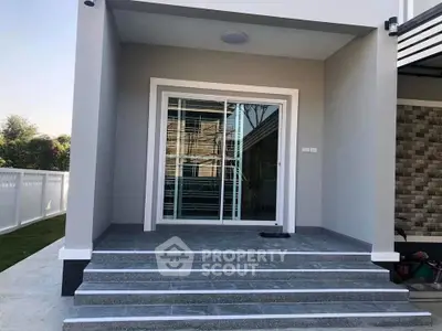Modern house entrance with sleek glass door and elegant steps