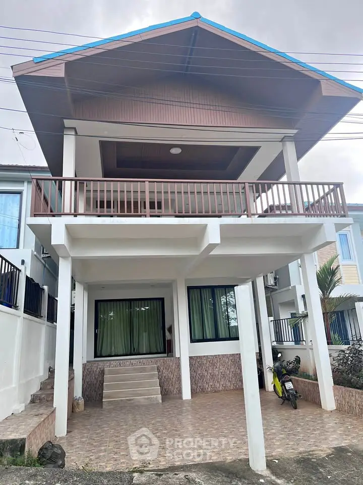 Charming two-story house with spacious balcony and modern design.