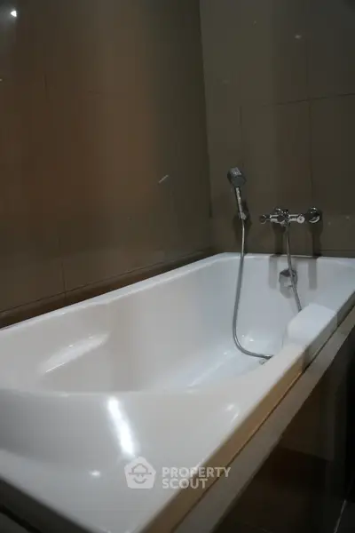 Modern bathroom with sleek bathtub and elegant fixtures, perfect for relaxation and comfort.