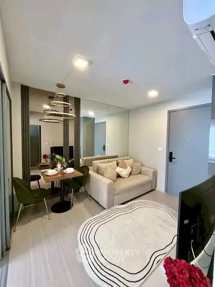 Modern living room with stylish decor and dining area in a cozy apartment.