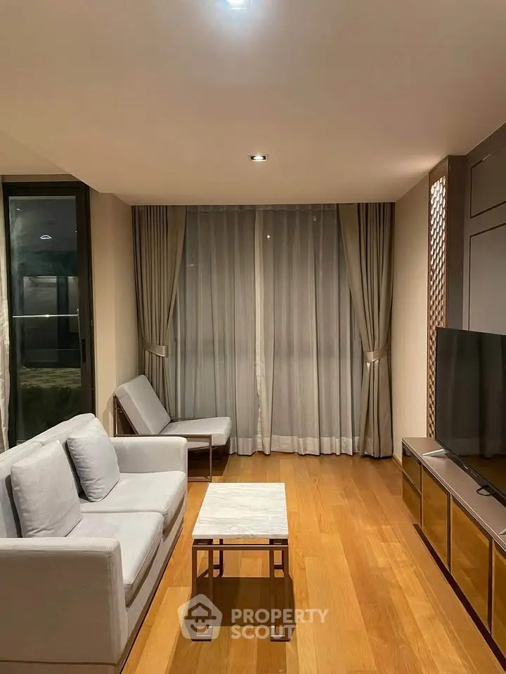 Modern living room with wooden flooring and elegant furniture