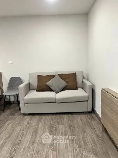 Modern living room with stylish sofa and wooden flooring in a cozy apartment.