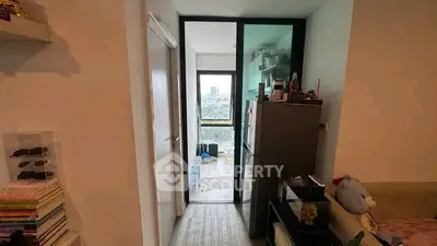 Cozy apartment hallway with modern decor and city view through glass door.