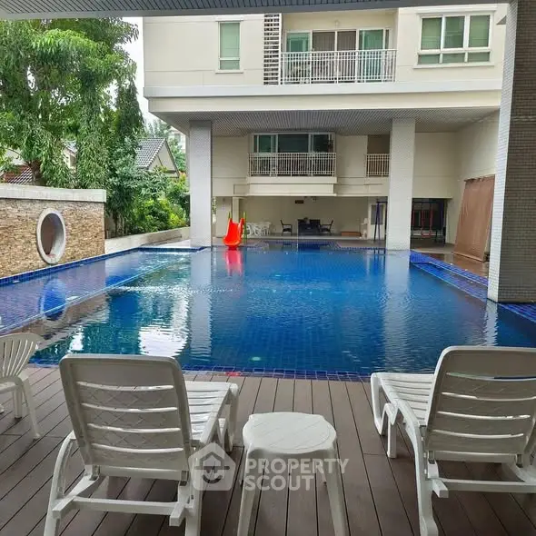 Luxurious residential pool area with modern design and comfortable seating