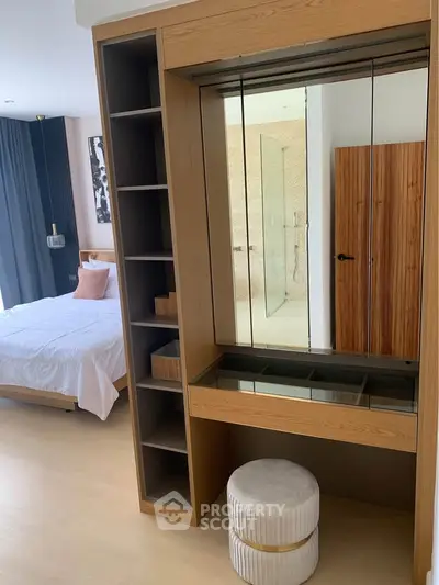 Modern bedroom with stylish wooden furniture and elegant decor, featuring a cozy bed and a sleek vanity area.