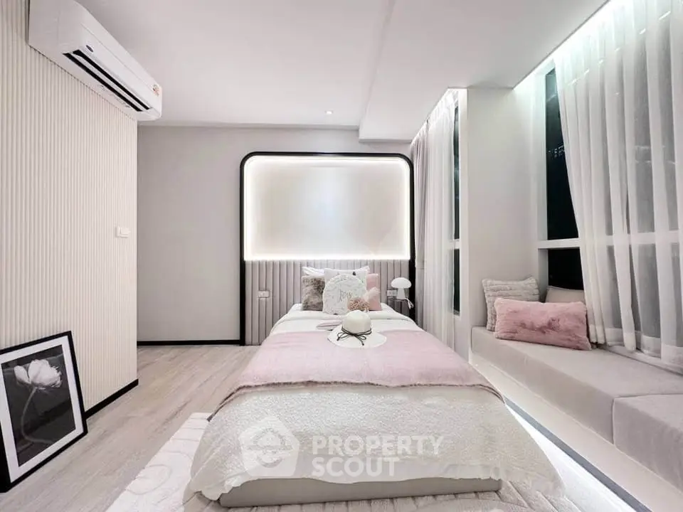 Elegant modern bedroom with soft lighting and cozy decor, featuring a large window seat and stylish air conditioning.