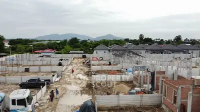 Expansive view of residential construction site with multiple houses in progress, showcasing future suburban development.