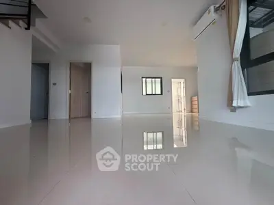 Spacious modern living room with glossy floors and natural light