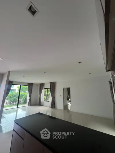 Spacious modern living room with large windows and garden view