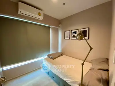 Cozy bedroom with modern decor and air conditioning, perfect for restful nights.
