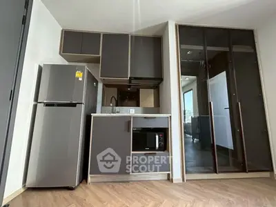Modern kitchen with sleek cabinetry and appliances in a stylish apartment