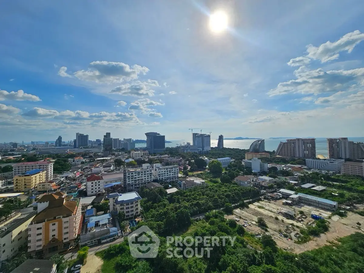 Stunning cityscape view with ocean horizon and lush greenery, perfect for urban living.