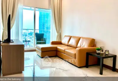 Modern living room with leather sofa and city view balcony in high-rise apartment.
