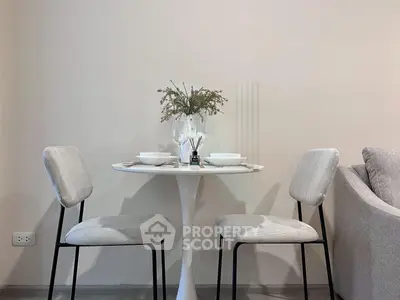 Chic modern dining area with elegant round table and stylish chairs, perfect for cozy meals.
