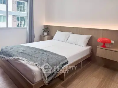 Modern bedroom with minimalist design, featuring a cozy bed, wooden flooring, and ambient lighting.