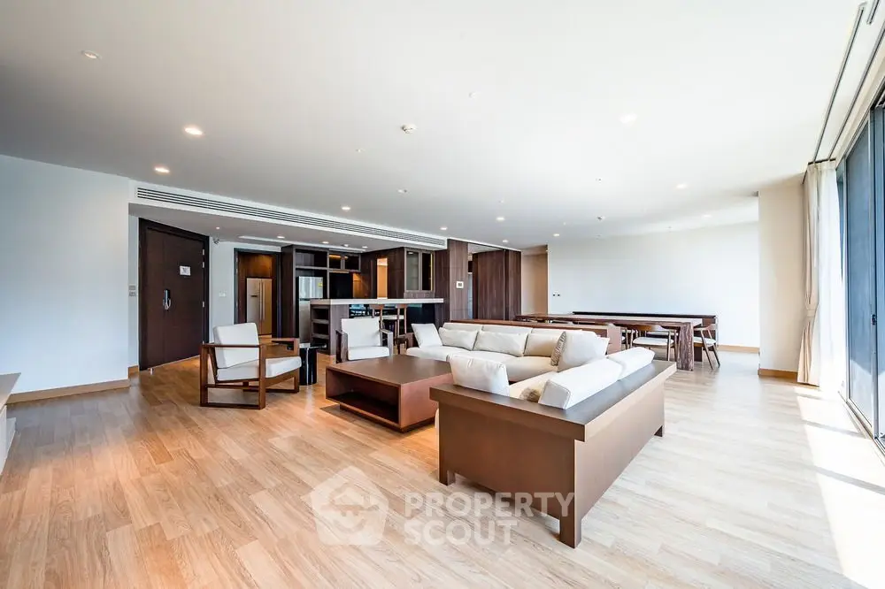 Spacious modern living room with sleek design and ample natural light.
