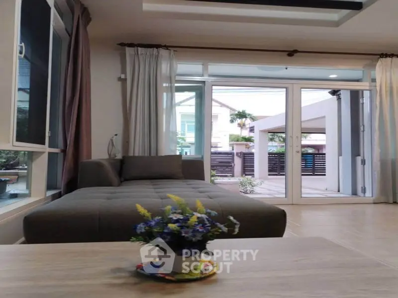 Spacious living room with large windows and modern decor