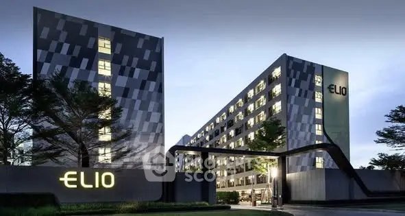Modern architectural building with sleek design and illuminated facade at dusk.