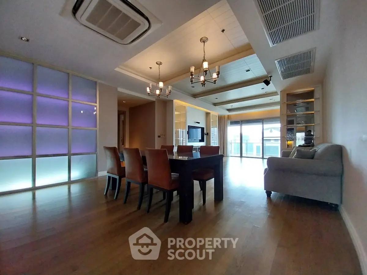 Spacious modern living room with elegant dining area and ambient lighting.