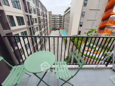 Modern apartment balcony with pool view and stylish outdoor furniture.