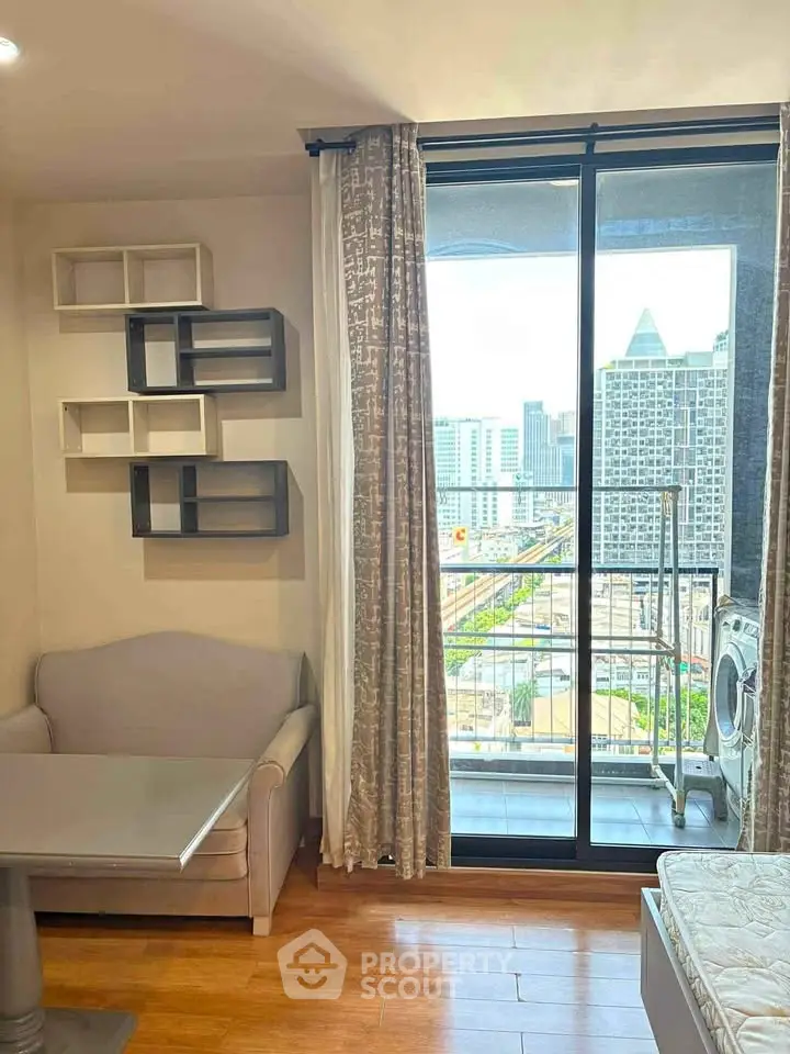 Modern apartment with city view, featuring a cozy living area and balcony access.