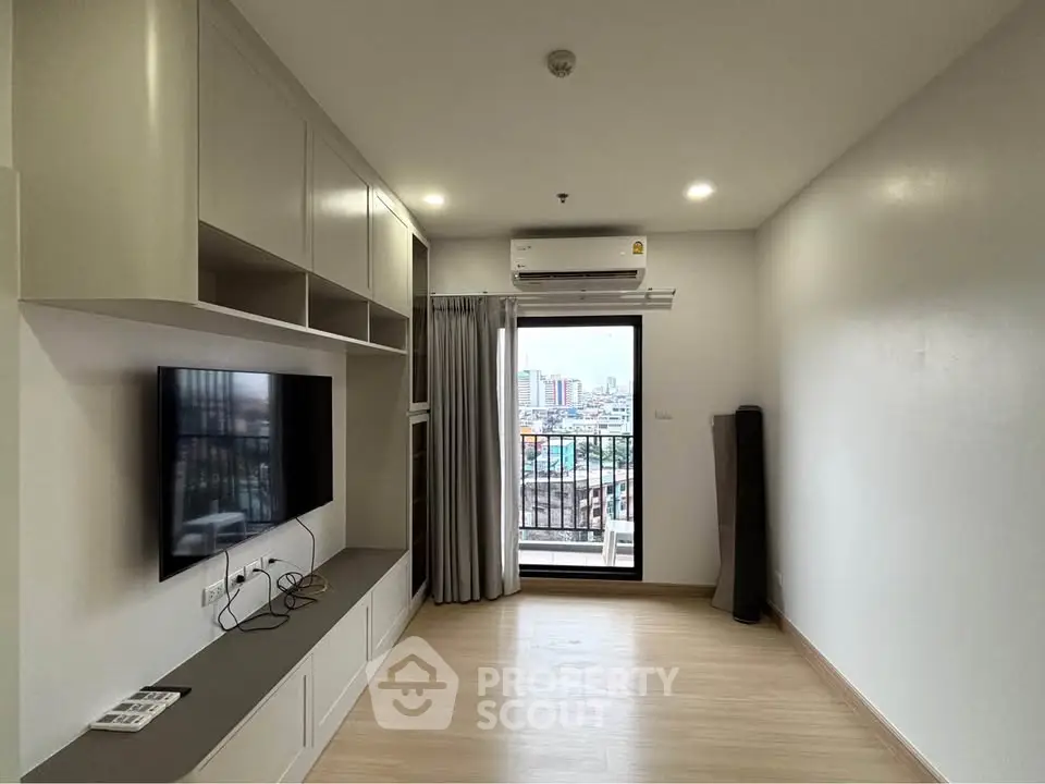 Modern living room with built-in TV unit and city view balcony