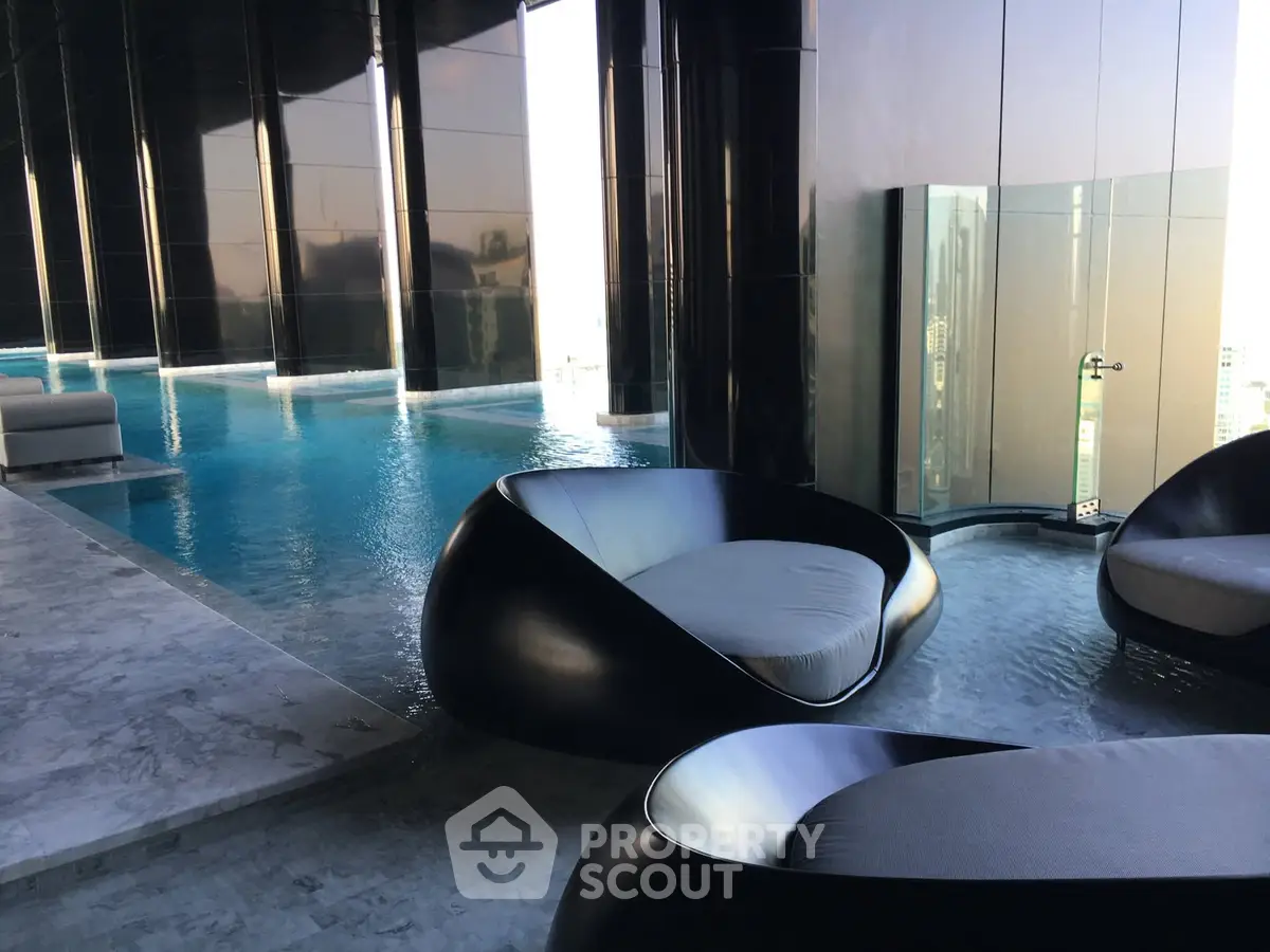 Luxurious rooftop pool with modern seating and stunning city views.