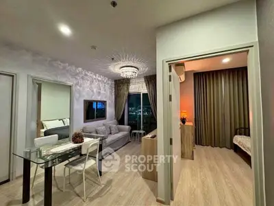Modern living room with elegant chandelier and city view, adjacent to cozy bedroom.