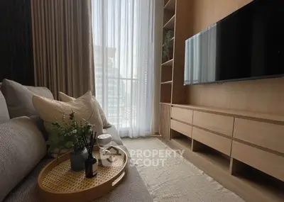 Modern living room with sleek TV setup and cozy seating area, perfect for relaxation.