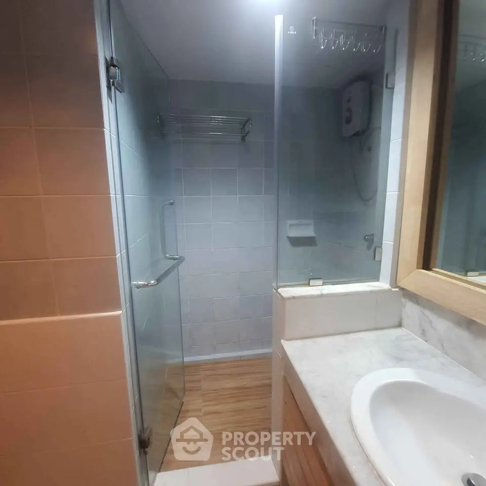 Modern bathroom with glass shower enclosure and sleek sink design