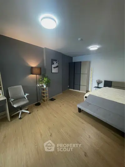 Modern bedroom with stylish decor and wooden flooring