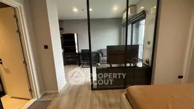 Modern apartment interior with glass partition and stylish furnishings