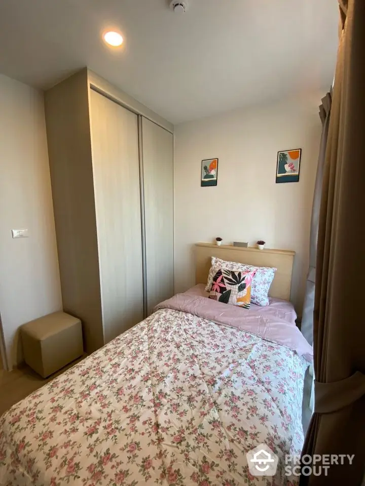 Cozy bedroom with floral bedding and modern decor in a stylish apartment