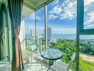 Stunning high-rise balcony with ocean view and modern outdoor seating