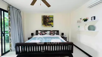 Charming bedroom with elegant decor and natural light, featuring a cozy bed and stylish wall art.