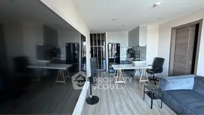 Modern open-layout living room with sleek kitchen and stylish furnishings
