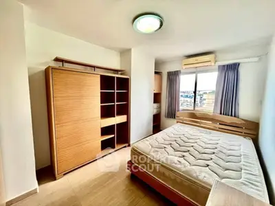 Spacious bedroom with natural light and modern furnishings