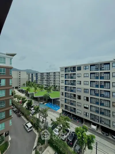 Modern apartment complex with spacious parking and lush greenery