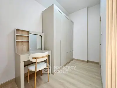Modern minimalist bedroom with sleek wardrobe and stylish vanity desk.
