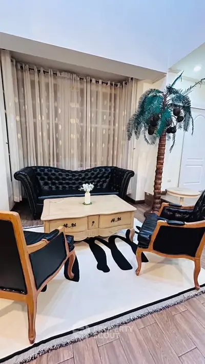 Elegant living room with black leather furniture and stylish decor