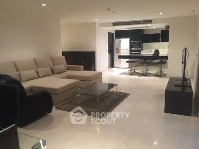 Spacious modern living room with open kitchen and sleek furnishings