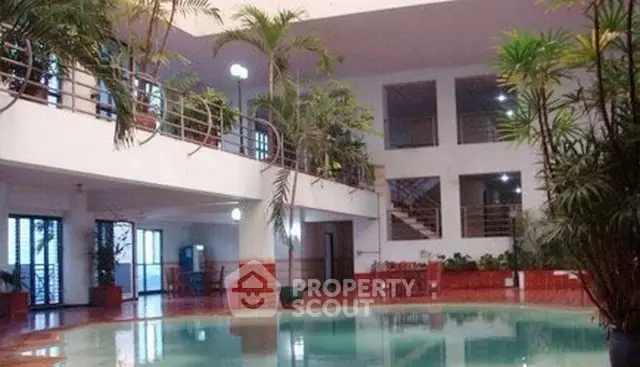 Luxurious indoor pool area with lush greenery and modern design